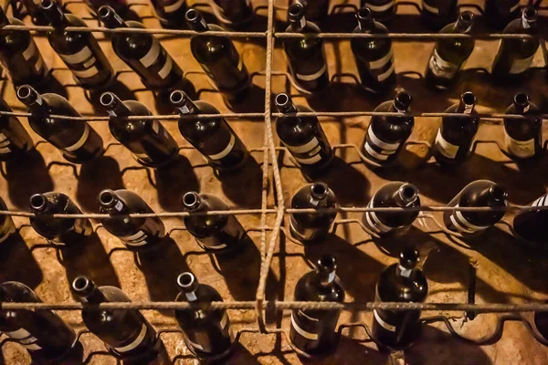 Stacked up wine bottles in the cellar, dusty but tasty — Stock Photo, Image