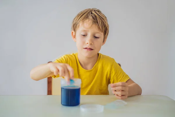Chemical home tests. Tools for the home lab. the boy Explorer. Child is watching a chemical reaction. The young chemist doing scientific experiments. physical experiment inside