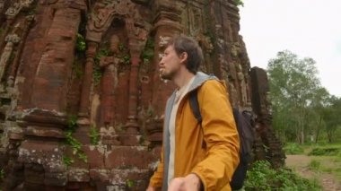 Family visits ruins in the My Son Sanctuary, remains of an ancient Cham civilization in Vietnam. Tourist destination in the city of Danang. Travel to Vietnam concept