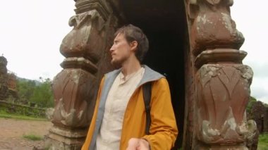Family visits ruins in the My Son Sanctuary, remains of an ancient Cham civilization in Vietnam. Tourist destination in the city of Danang. Travel to Vietnam concept