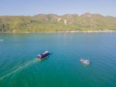Top view of a boat sailing in the blue sea