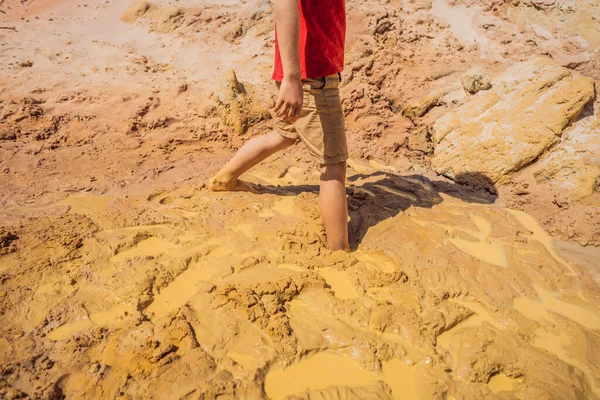 Unlucky buried person standing in natural quicksand river, clay sediments, sinking, drowning quick sand, stuck in the soil, trapped and stuck concept