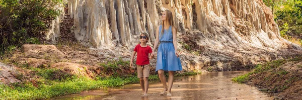 Mom and son tourists on the Fairy stream among the red dunes, Muine, Vietnam. Vietnam opens borders after quarantine COVID 19 BANNER, LONG FORMAT
