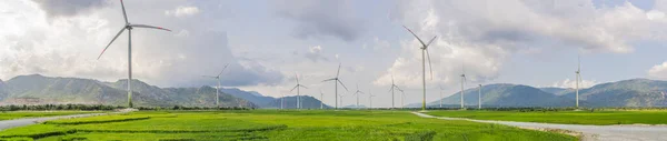 Wind power plant. green meadow with Wind turbines generating electricity