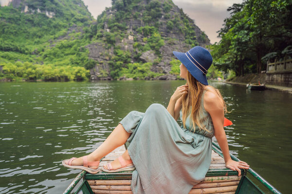 Woman tourist in Trang An Scenic Landscape Complex in Ninh Binh Province, Vietnam A UNESCO World Heritage Site. Resumption of tourism in Vietnam after quarantine Coronovirus COVID 19