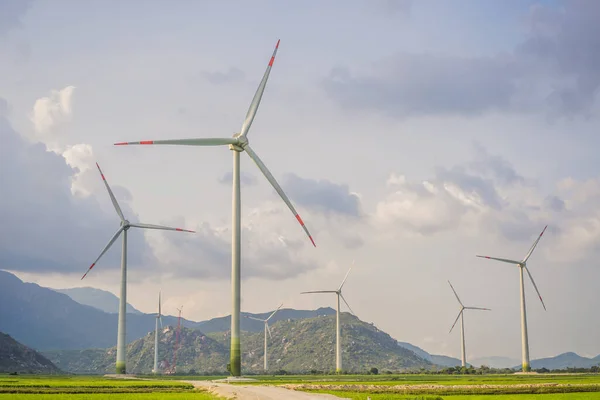 Wind power plant. green meadow with Wind turbines generating electricity