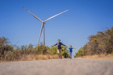 Alternatif enerji, rüzgar çiftliği ve ailenle mutlu zaman geçirmek. Mutlu baba oğluyla yolda tatilde ve doğaya kaçıyor. Baba ve oğul kollarını yel değirmeni gibi sallıyor.