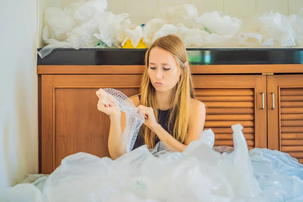 Woman used too many plastic bags that they filled up the entire kitchen. Zero waste concept. The concept of World Environment Day — Stock Photo, Image