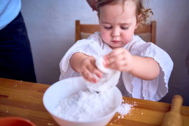           Annem ve huysuz bir çocuk mutfakta zencefilli kurabiye evi için krema pişiriyorlar.                     