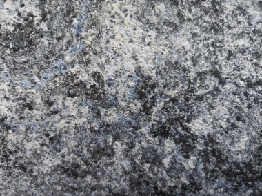 Abstract stone texture background with natural speckled details in gray, black, and blue tones. Perfect for design, art, and creative projects.