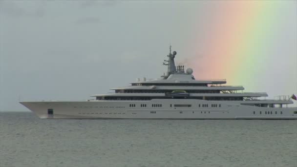 Rainbow over yacht in ocean — Stock video