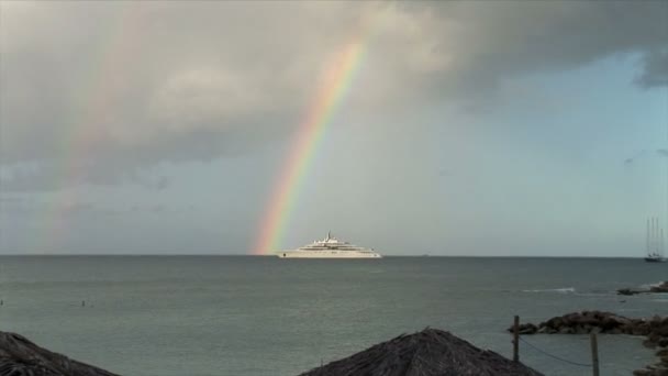 Rainbow over yacht in ocean — Stock Video