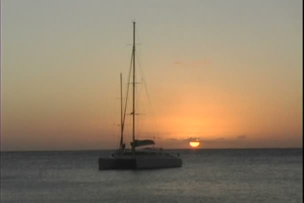 Katamaran łodzią w morze o zachodzie słońca — Wideo stockowe