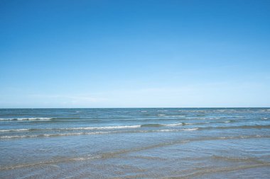 Beyaz kumlu güzel sahil, turkuaz okyanus suyu ve güneşli bir günde bulutlu mavi gökyüzü. Huahin, Tayland 'da