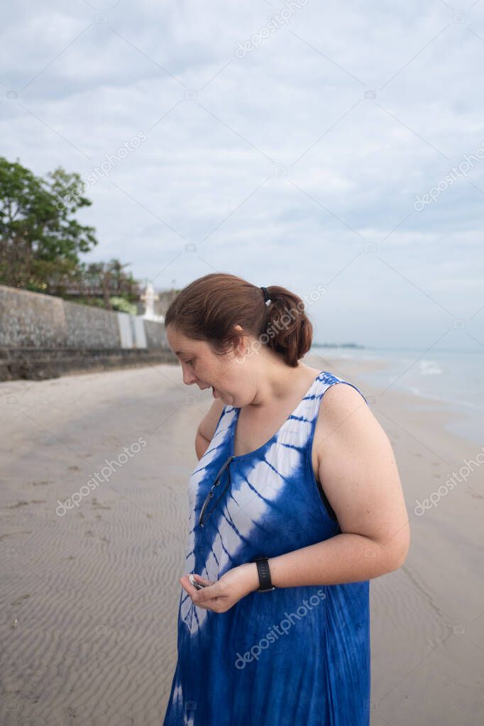 Beautiful happy woman walking on the beach 
