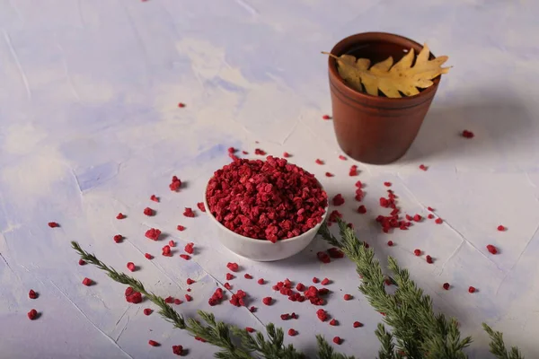 dried freeze dried raspberries are on the table with tea