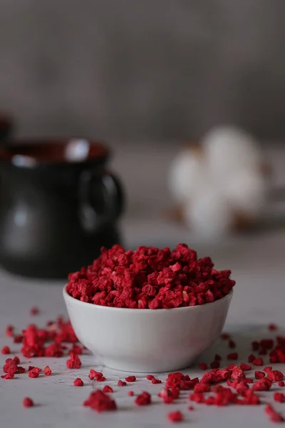 dried freeze dried raspberries are on the table with tea