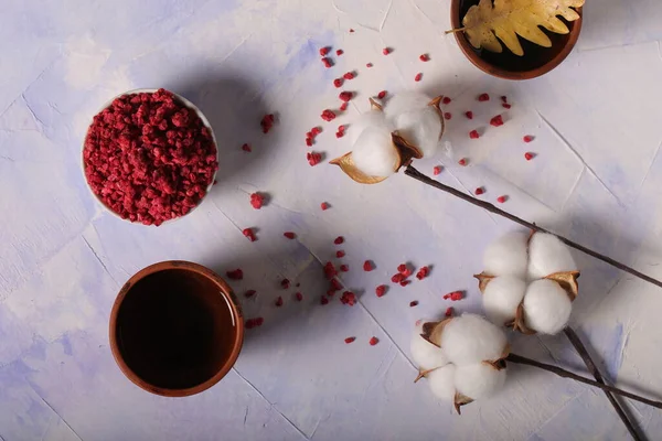 dried freeze dried raspberries are on the table with tea