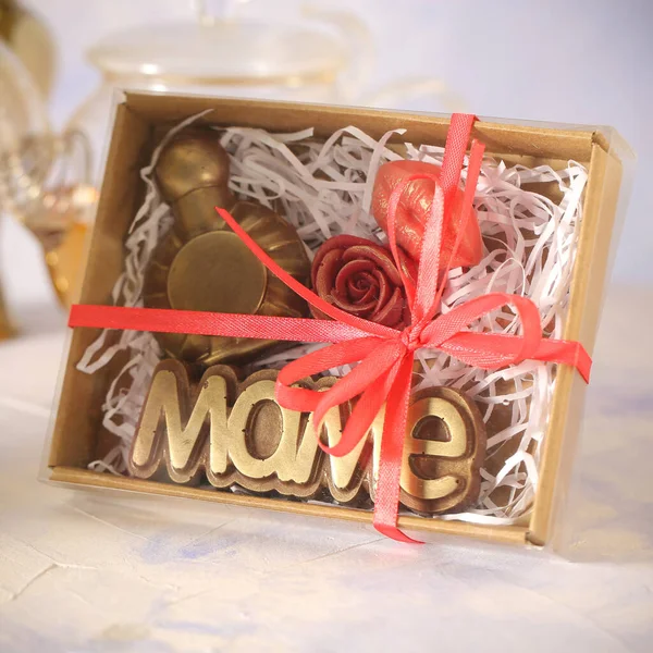 handmade chocolate and flowers are on the table