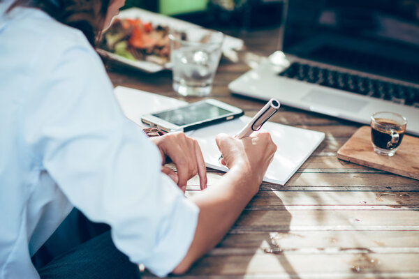 Woman taking notes on paper