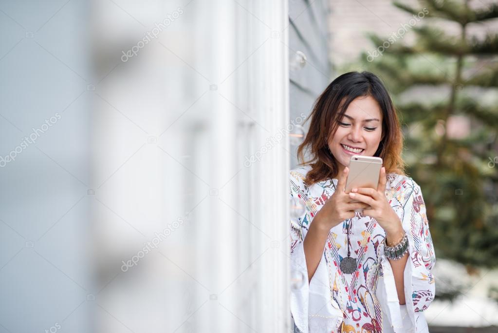 Photos of Asian woman looking at the phone