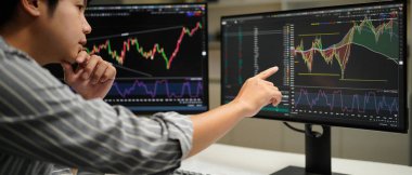 Cropped photo of businessman analyzing business diagram, marketing statistics and finance market graphs on computer monitor in the office..
