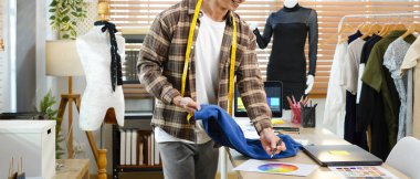 Moda tasarımcısı olarak çalışan erkekler, iş yerindeki kıyafet için renk çizelgesi seçiyorlar..