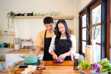 Aşk, yemek ve aşçılık mutfakta bir çiftle kahvaltı, sabah ve mutluluk için kucaklaşmalar. Gülümse, dikkat et ve beslen. Mutlu olmak için evde yemek yiyen erkek ve kadınla..