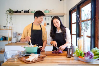 Aşk, yemek ve aşçılık mutfakta bir çiftle kahvaltı, sabah ve mutluluk için. Gülümse, dikkat et ve beslen. Mutlu olmak için evde yemek yiyen erkek ve kadınla..