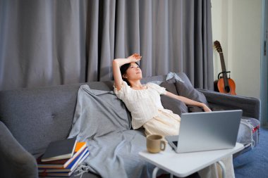 Düşünceli genç kadın sıkılmış uzak kanepede eğitim çalışmalarında, mutsuz ilgisiz depresif oturan rahat ev hissi seyir yorgun kayıtsız genç kaybettim düşüncelerini melankolik demotivated.