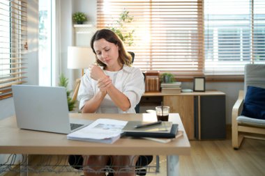 İş kadını ya da ofis bilgisayarını kullanmaktan dolayı el ağrısını tutan serbest çalışan biri. Ofis sendromu kavramı.