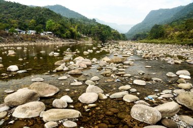 Tranquil Mountain River Scene With Pebble Beach, Forest, and Distant Ranges