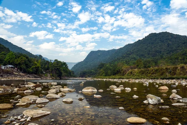 Tranquil Mountain River Scene With Pebble Beach, Forest, and Distant Ranges