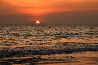 Serene Ocean Sunset Over Calm Waves With Vivid Warm Colors