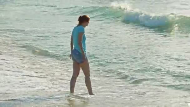 Young woman with red hair in glasses visits sea first time and play with waves, beach of Dominican Republic — Stock Video