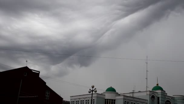 Time lapse of storm clouds growing over buildings of city — Stock Video