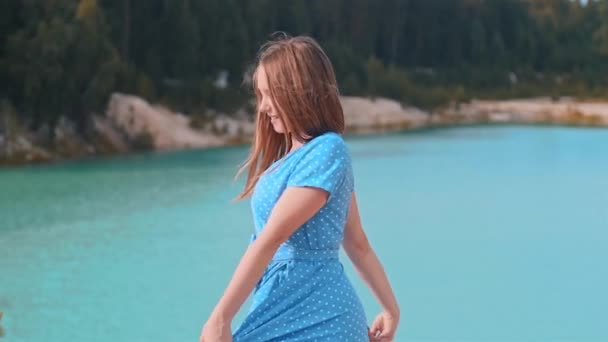 Happy pretty woman on a background of blue lake — Stock Video