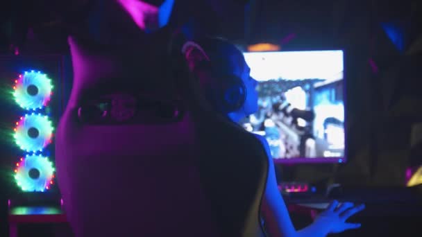 Mujer joven jugando un juego en línea en el club de juego - se molesta y se convierte a la cámara con una cara triste — Vídeos de Stock