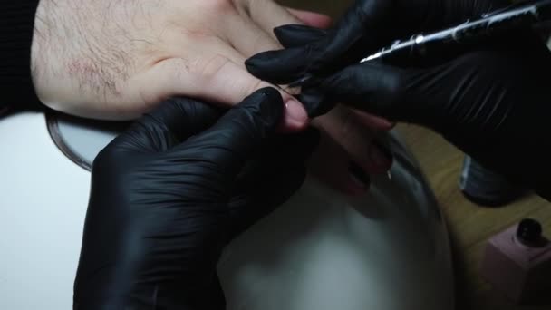 Manicure - meester schilderen van het ontwerp met een zwarte nagellak — Stockvideo