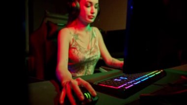 Neon oyun kulübünde bir sürü dövmesi olan seksi genç bir kadın.