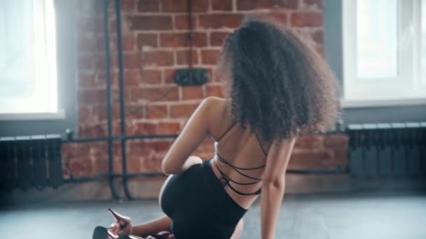Dança de strip - jovem mulher encaracolada fazendo movimentos no chão — Vídeo de Stock