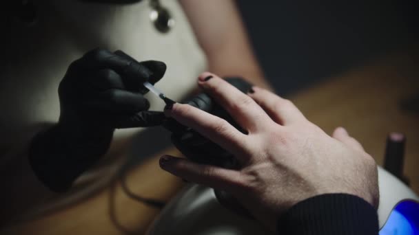 Męski manicure - mistrz nakładający top na paznokcie nad minimalistycznym designem — Wideo stockowe