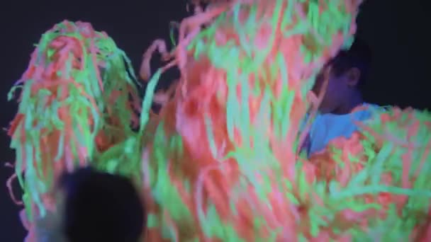Små barn leker med färgglada band medan showen i neon rum — Stockvideo