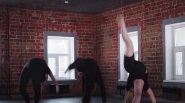 Fitness - üç genç esnek kadın ters takla atıyor