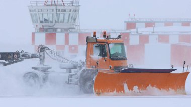 Karlı kış - turuncu bir kar kamyonu yolu kardan temizliyor