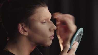 Sürükleme sanatçısı - genç bir adam kaşlarının kalın temelinde kaynaşıyor