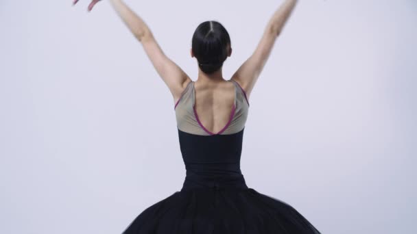 Young woman ballerina in black dress from the back — Stock Video