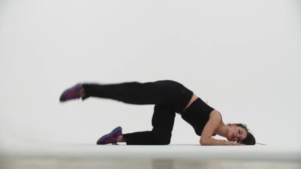 Dancing - young stylish woman dancing on the floor on white background — Stock Video