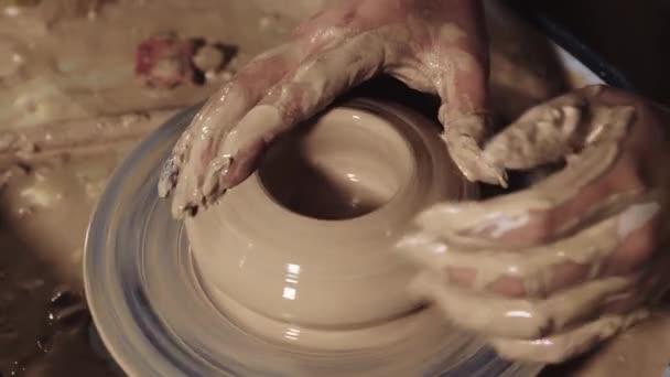 Pottery crafting - womans hands forms clay in the a pot shape smoothing the surface — Stock Video