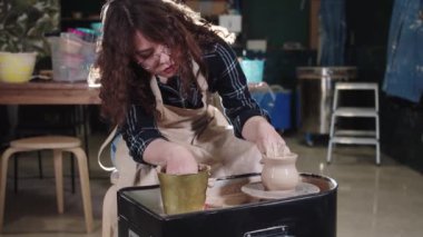 Sanat stüdyosunda çömlekçilik - kadın basit bir çömlek yapıyor